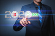 © Panya Studio - Businessman pressing 2020 start up business flat icon over gradient light blue background, Start up business of the new year 2020, Business happy new year cover concept - Image