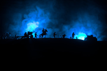 War Concept. Military silhouettes fighting scene on war fog sky background, World War German Tanks Silhouettes Below Cloudy Skyline At night. Attack scene. Armored vehicles and infantry.