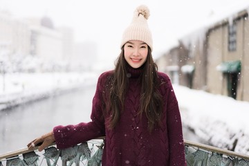 Beautiful young asian woman smile and happy with travel trip in Otaru canal Hokkaido Japan