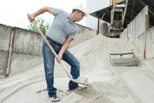 Manual Worker Digging Sand With Shovel