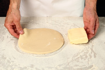 Making Puff Pastry. Place butter in centre of dough.