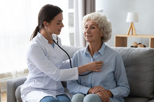 Young Woman Doctor Holding Stethoscope Examining Senior Grandma Patient