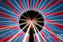 Long Exposure Zoom Of A Ferris Wheel At Night