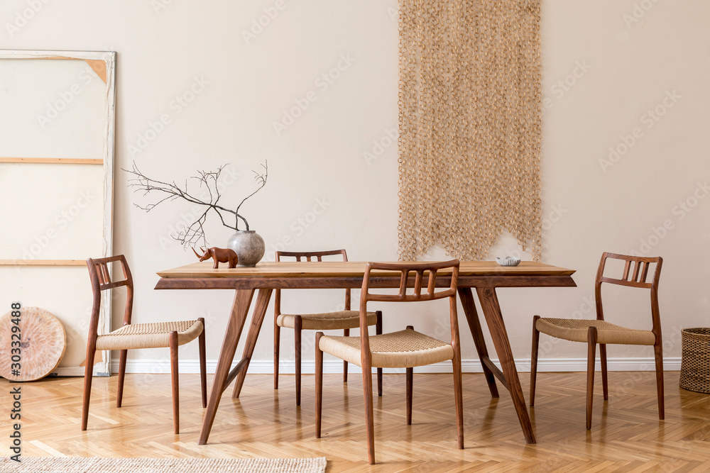 Stylish and beige interior of dining room with design wooden table and chairs, vase with flowers, sculpture, elegant and rattan accessories. Korean style of home decor.  Wooden parquet. Template. - obrazy, fototapety, plakaty 
