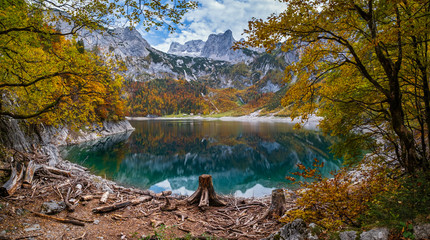  Picturesque Hinterer Gosausee lake, Upper Austria. Colorful autumn alpine view of mountain lake with clear transparent water and reflections. Dachstein summit and glacier in far.