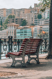 Fototapeta Miasto - Red bench in front of Lugano Lake in Switzerland in summer time
