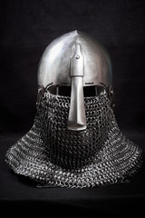 Knight helmet on a black background. Front view.