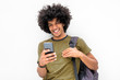© mimagephotos - cool young guy with bag looking at cellphone and smiling