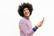 © mimagephotos - happy young arab guy holding cellphone by isolated white background