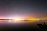 Fototapeta Niebo - Starry sky over the lake. Starry sky background picture of stars in night sky and the Milky Way.