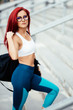 Sexy fitness girl doing fitness exercises and working out on stadium stairs. Jogger on morning training, healthy lifestyle routine concept