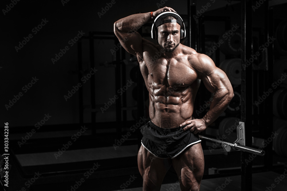 Muscular athletic bodybuilder fitness model training and posing with ...