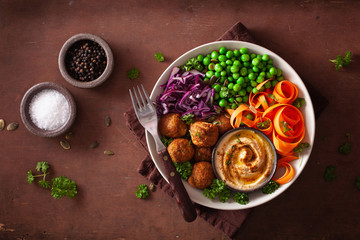 Canvas Print - healthy vegan lunch bowl with falafel hummus carrot ribbons cabbage and peas