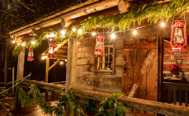 Tiny and Cozy house Cabin Exterior with Christmas lights. Ideal picture that brings up holiday spirit.