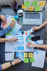 Wall Mural - smooth focus,a group of web designers are working together to develop a mobile responsive website wi