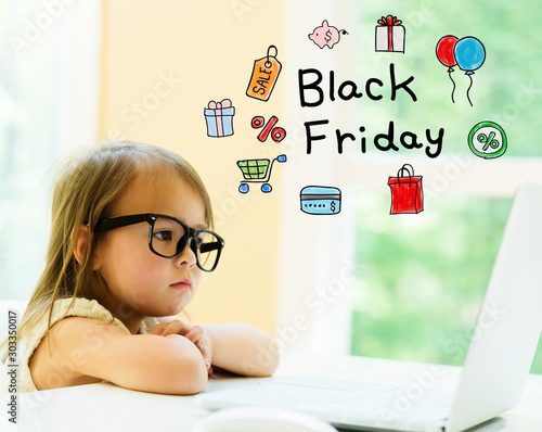 Fotografering Black Friday text with little girl using her laptop