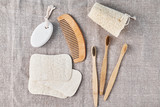 Fototapeta Sypialnia - Natural set for bathing bamboo toothbrushes,  luffa spongle and wooden hairbrush on a linen background. Zero waste no plastic concept