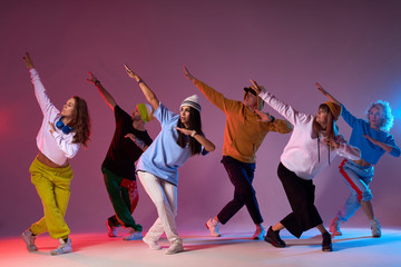 Modern dancers posing in front of studio background, performing modern dance element, professional group of dancers preparing for concert, practicing movies