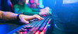 Leinwandbild Motiv Professional cyber video gamer studio room with personal computer armchair, keyboard for stream in neon color blur background. Soft focus