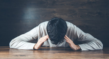 Wall Mural - sad man hand on head on dark background