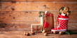 Santa´s shoe  -  Stuffed Santa Claus boot -  Gumboot,  paper bag, gift boxes and gingerbread man on rustic wood background  -  Christmas card 