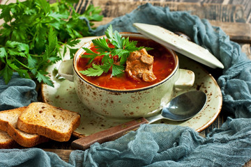 Wall Mural - Vegetables soup with beetroot, carrot, cabbage and potatoes in bowl on wooden table