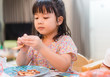 © MIA Studio - Little asian girl eating crab at home.Little girl enjoying a delicious crab.Seafood and Allergy food concept.
