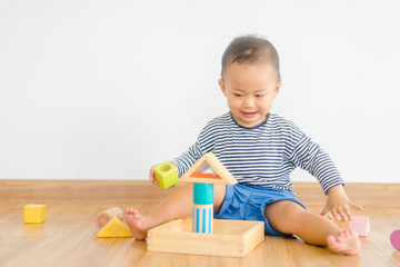 2 years baby boy.Little child boy playing with lots of wooden toys block with mother.Kids play with educational toys at home.Day care and Kindergarten school.child development concept.