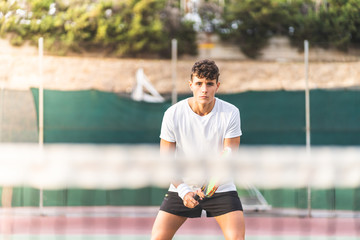 Wall Mural - Young Tennis Player Waiting the Ball Behind the Web.