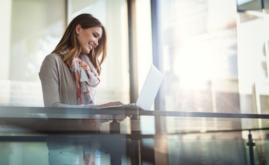 Beautiful young woman working as a freelancer on laptop