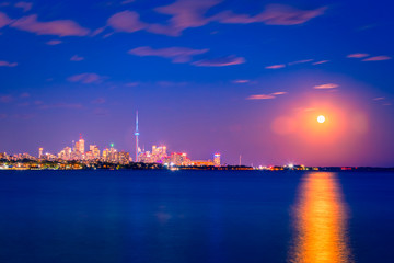 Wall Mural - View of Toronto skyline and Lake Ontario from Humber Bay Park area during night time. 