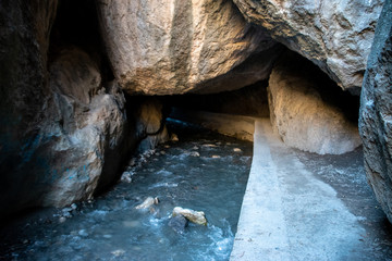 Wall Mural - Hiking the Los Cahorros trail through a gorge with a stream near Granada, Spain