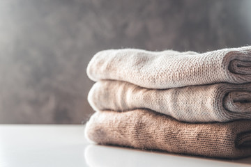 A stack of knitted sweaters ,the concept of warmth and comfort, hobby , background,closeup