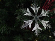 Snowflake ornament hanging on a Christmas Tree