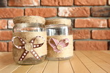 Fototapeta Kuchnia - DIY Home decor - decorated jars with natural string with a bow on the background of a brick wall