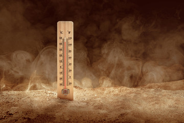 Wall Mural - Thermometer with high temperature on the desert with a dusty background