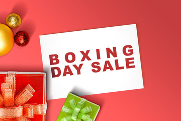 Wall Mural - Gift box with a ribbon and Christmas ornament with Boxing Day Sale text on paper