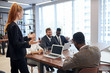 © alfa27 - Red haired young caucasian woman talk gesturing to young leaders gathered to listen to professional speech of business lady.
