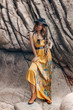 © zolotareva_elina - cheerful beautiful young boho style model on the stone beach