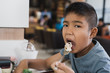 © arcyto - Asian boy enjoy eating ice cream cake or honey banoffee toast menu at the restaurant.A kid eating dessert at the coffee shop.
