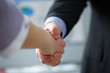 © H_Ko - Man in suit and tie give hand as hello in office
