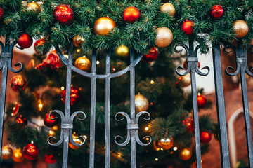 Wall Mural - Christmas decoration lies on the forged railing.