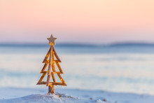 Christmas Tree With Fairy Lights On The Beach In Summer
