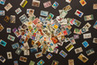 Various old postage stamps scattered on a dark background