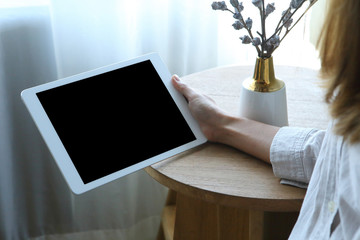 Business woman using tablet  with holding on wooden desk