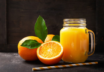 Wall Mural - glass jar of fresh orange juice with fresh fruits