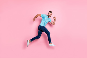 Poster - Full length body size photo of cheerful man wearing jeans denim footwear running jumping towards sales smiling toothily isolated pastel color background