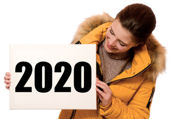 Wall Mural - Junge fröhliche Frau hält Schild mit 2020