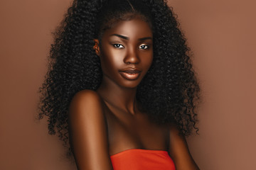 african beautiful woman portrait. brunette curly haired young model with dark skin and perfect smile