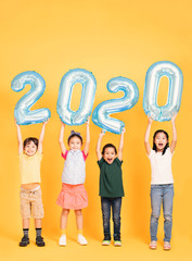 Wall Mural - Group of happy kids celebrating and showing 2020 new year concepts